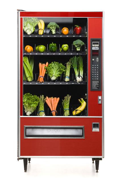a red vending machine full of vegetables