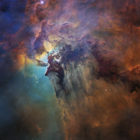 The Lagoon Nebula displays colorful clouds in space