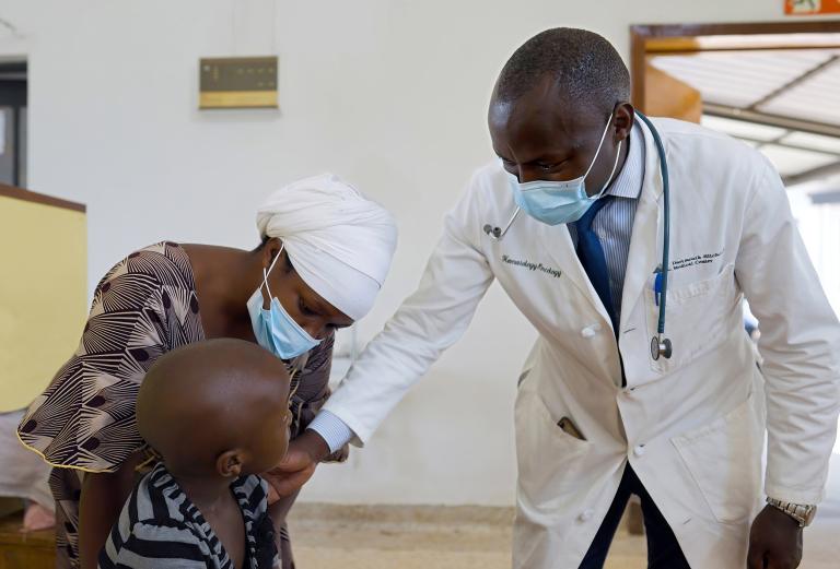 Dr. Cyprien Shyirambere examines a young child.