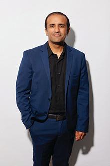 Raj Panjabi standing against a white background